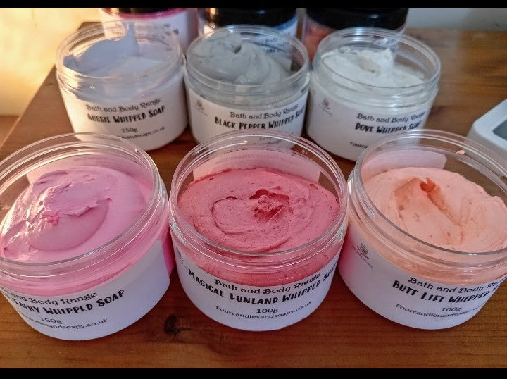 a variety of pot of various colour whipped soaps
