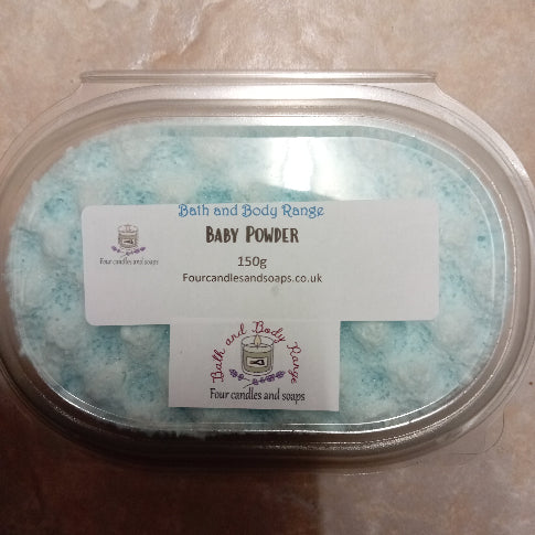 hand poured baby blue soap sponge in a container. Four candles and soaps