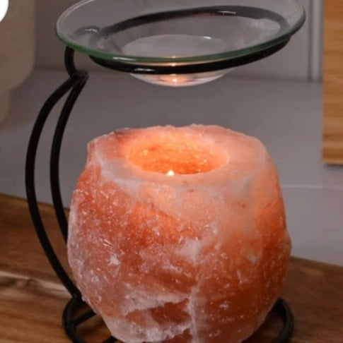 Himalayan salt lamp with glass bowl on a wooden surface