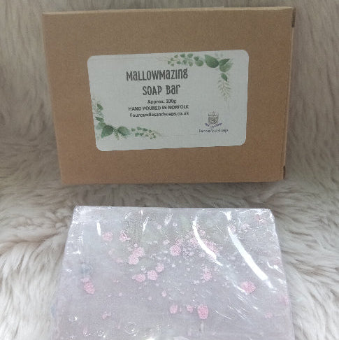 soap wraqpped in cellophone with a cardboard box four candles and soaps